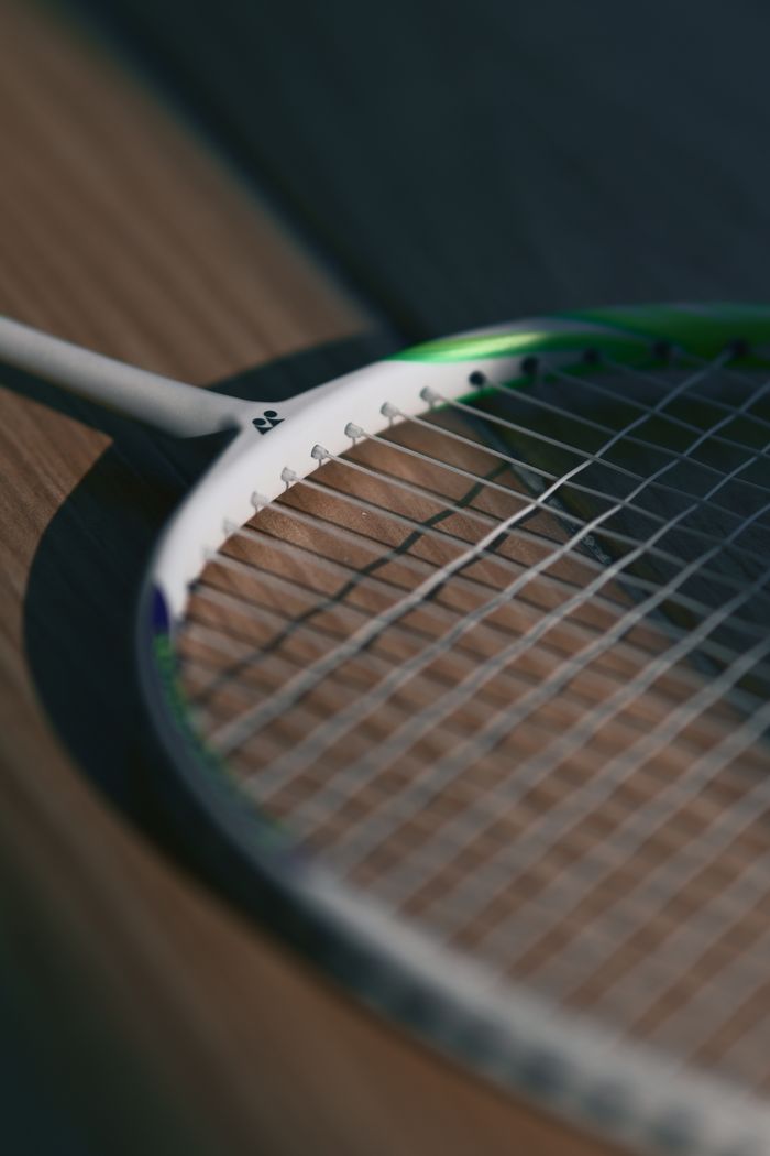Detailed image of a badminton shuttlecock highlighting its feathers and cork base.